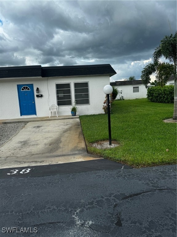 a front view of a house with a yard and a garage