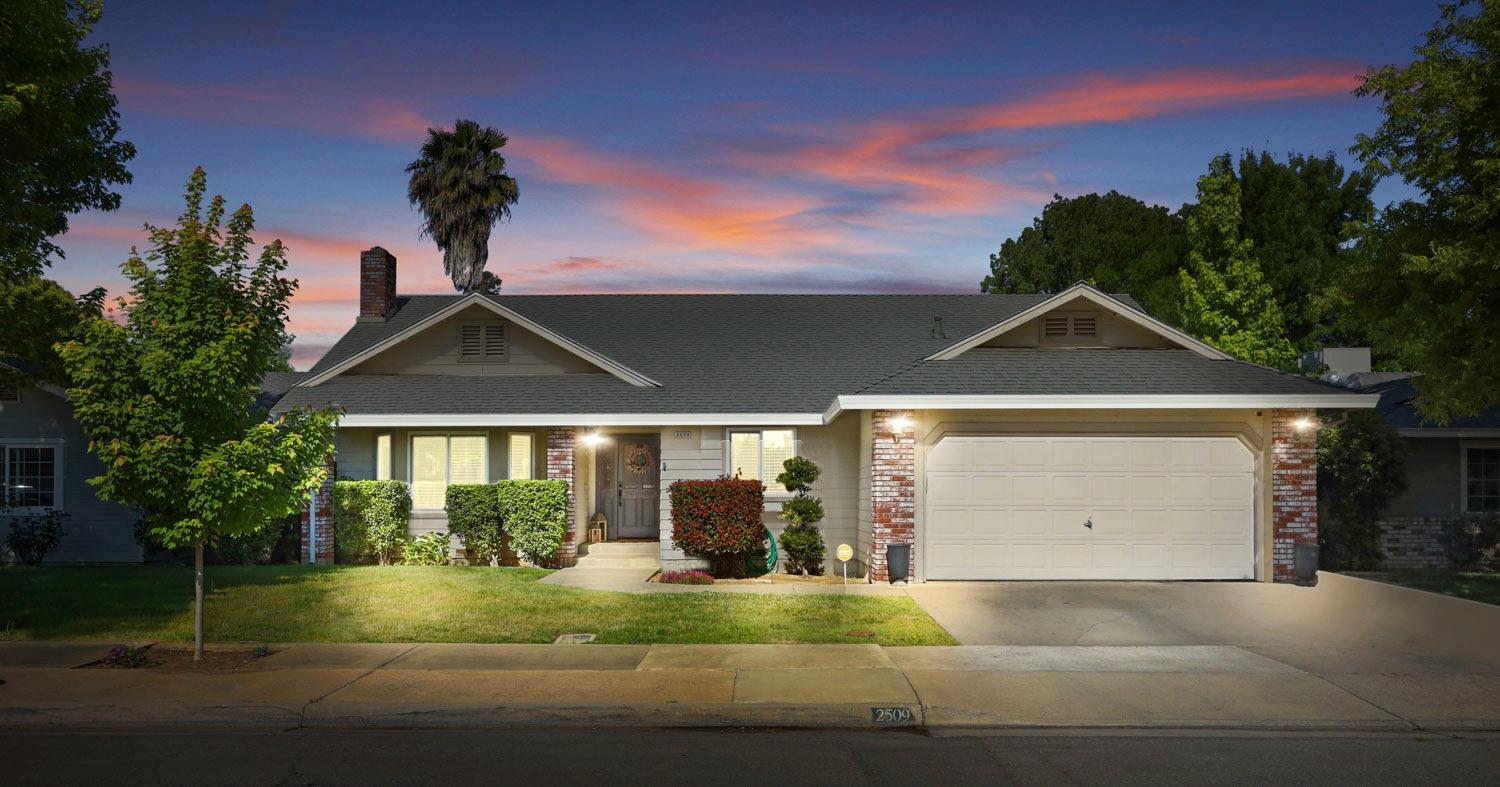 a front view of a house with a yard and garage