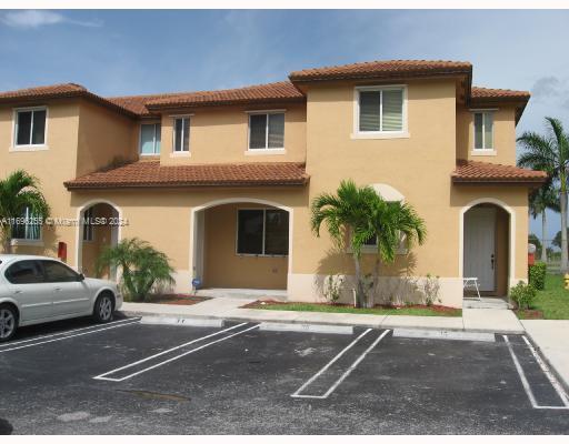 a front view of a house with a yard and a garage