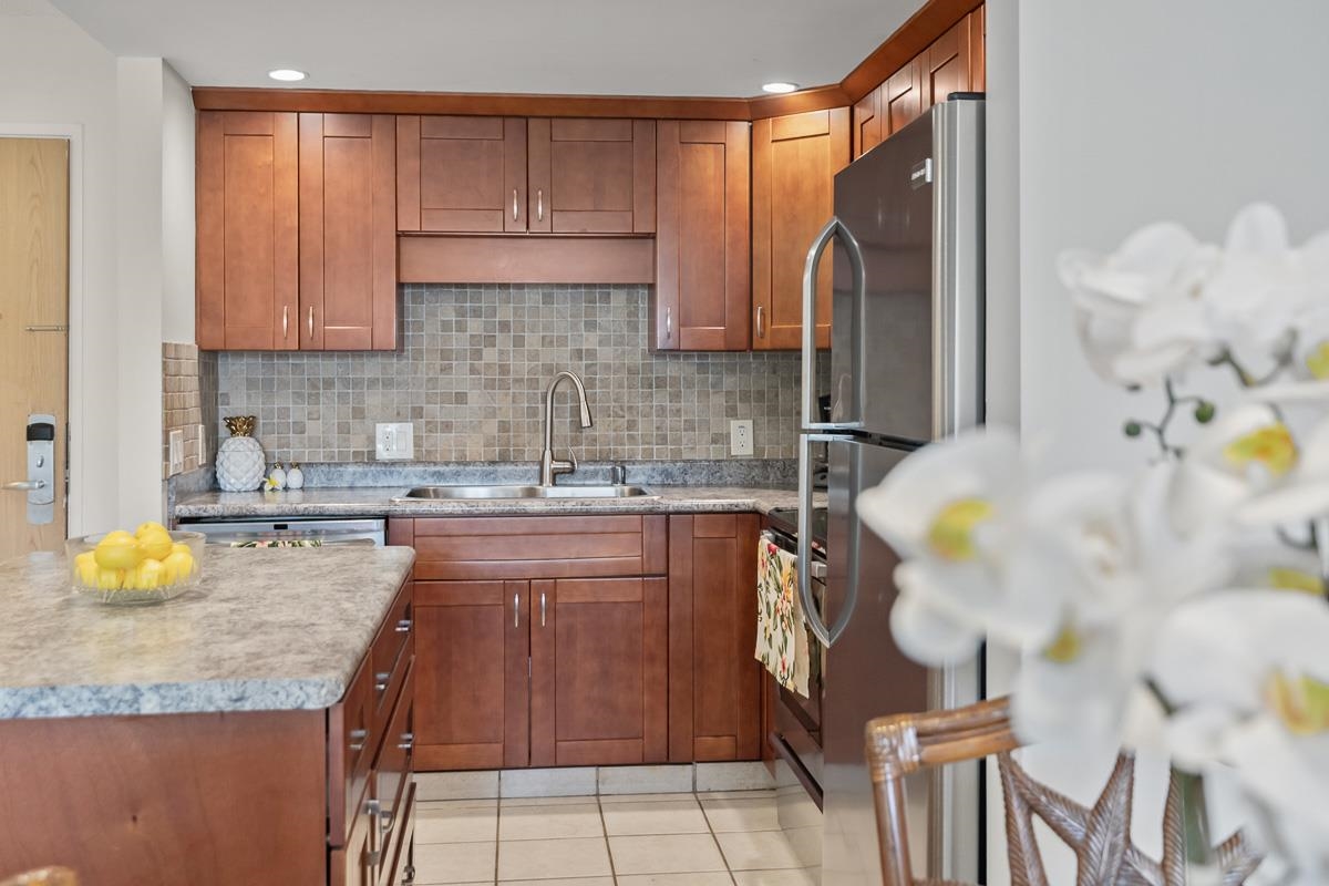 a kitchen with a sink refrigerator and cabinets