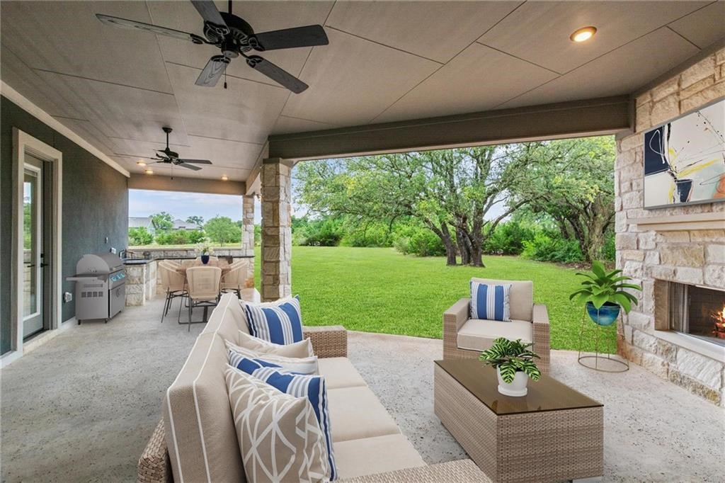 a view of a patio with couches potted plants and a big yard