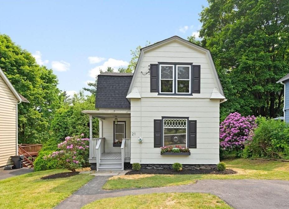 View of front of home with a front yard and covered porch