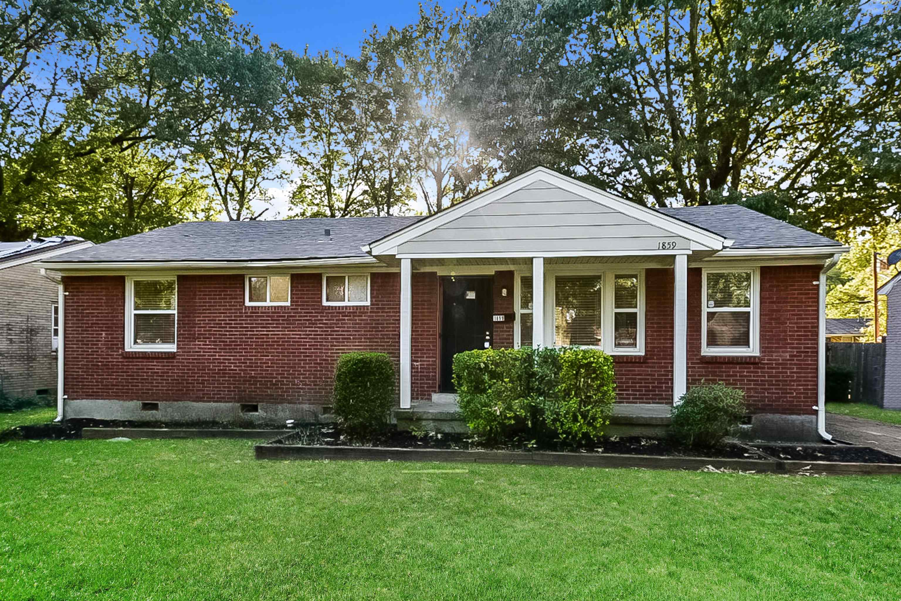 a front view of a house with a yard and porch