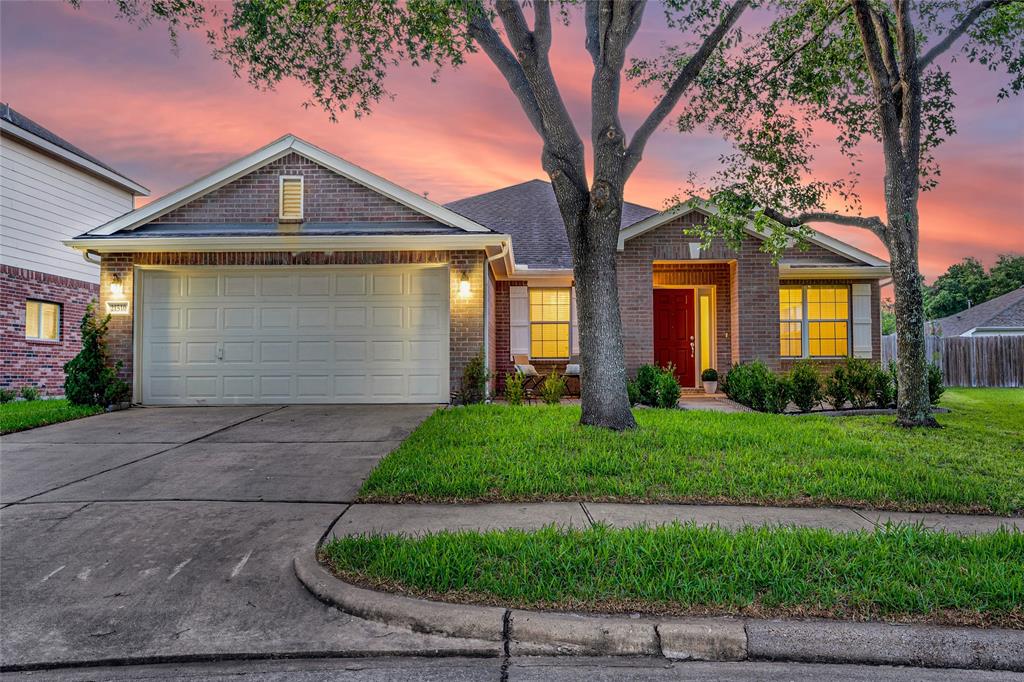 a front view of a house with a yard and garage