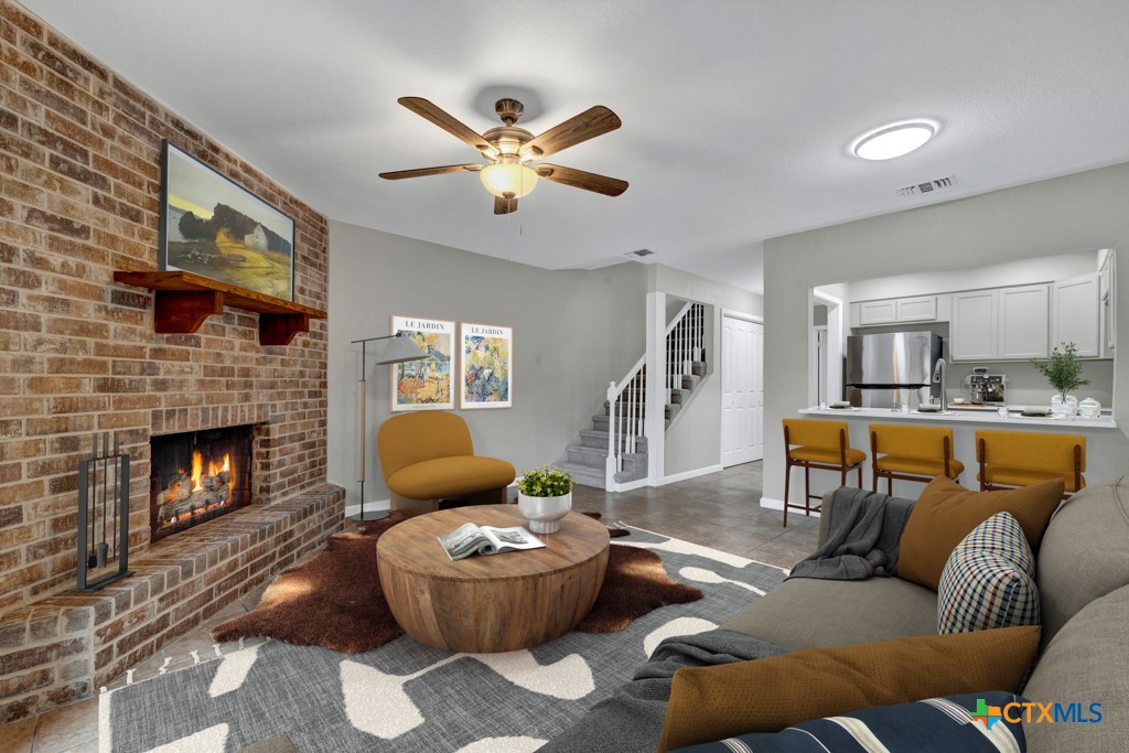 a living room with furniture and a fireplace