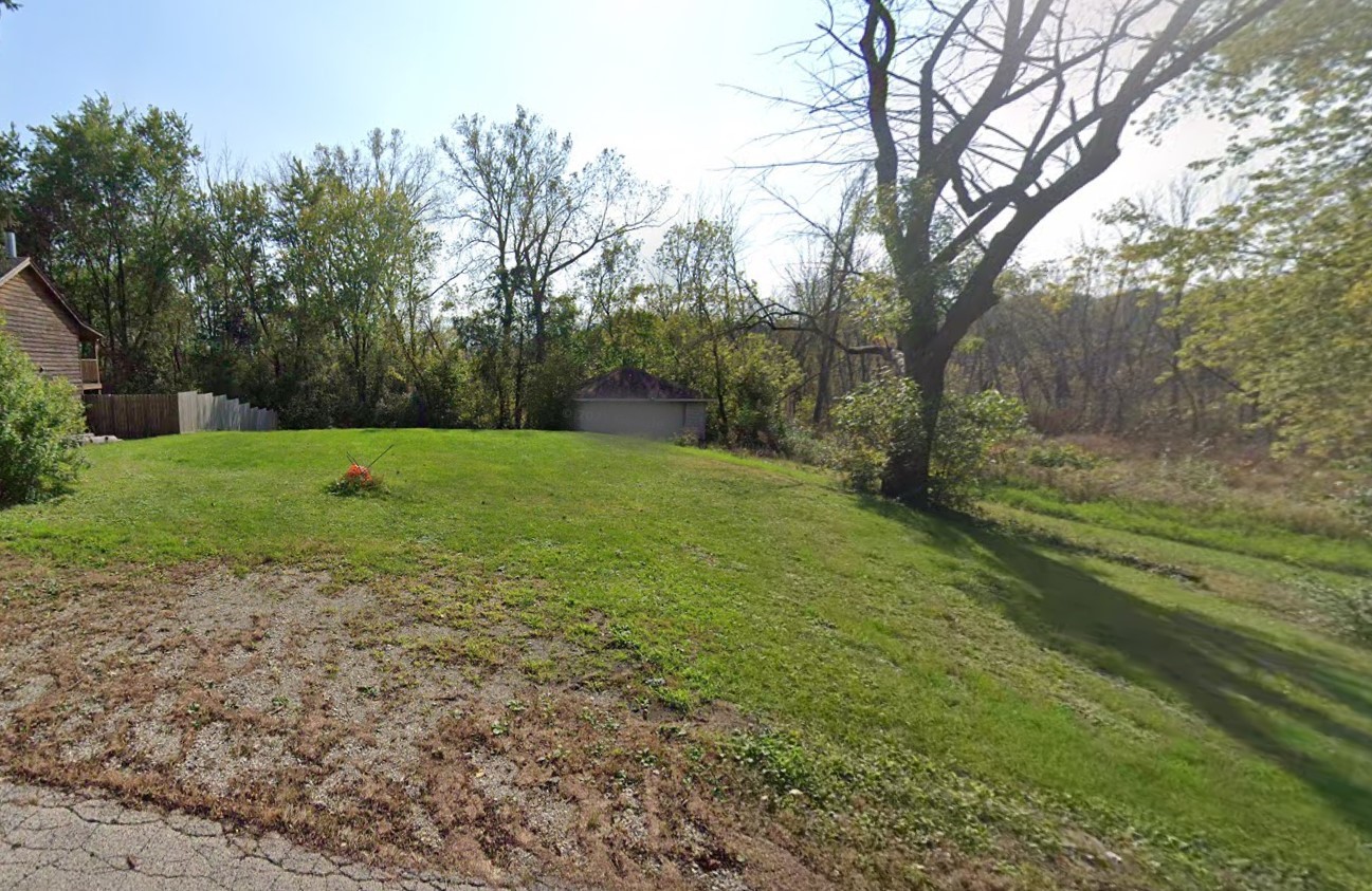 a view of a big yard with trees