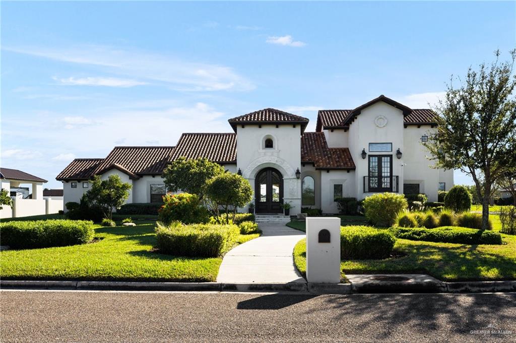 a front view of a house with garden and porch