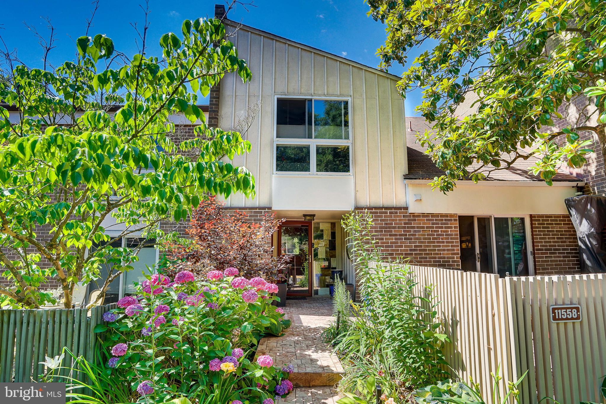 a view of a house with potted plants