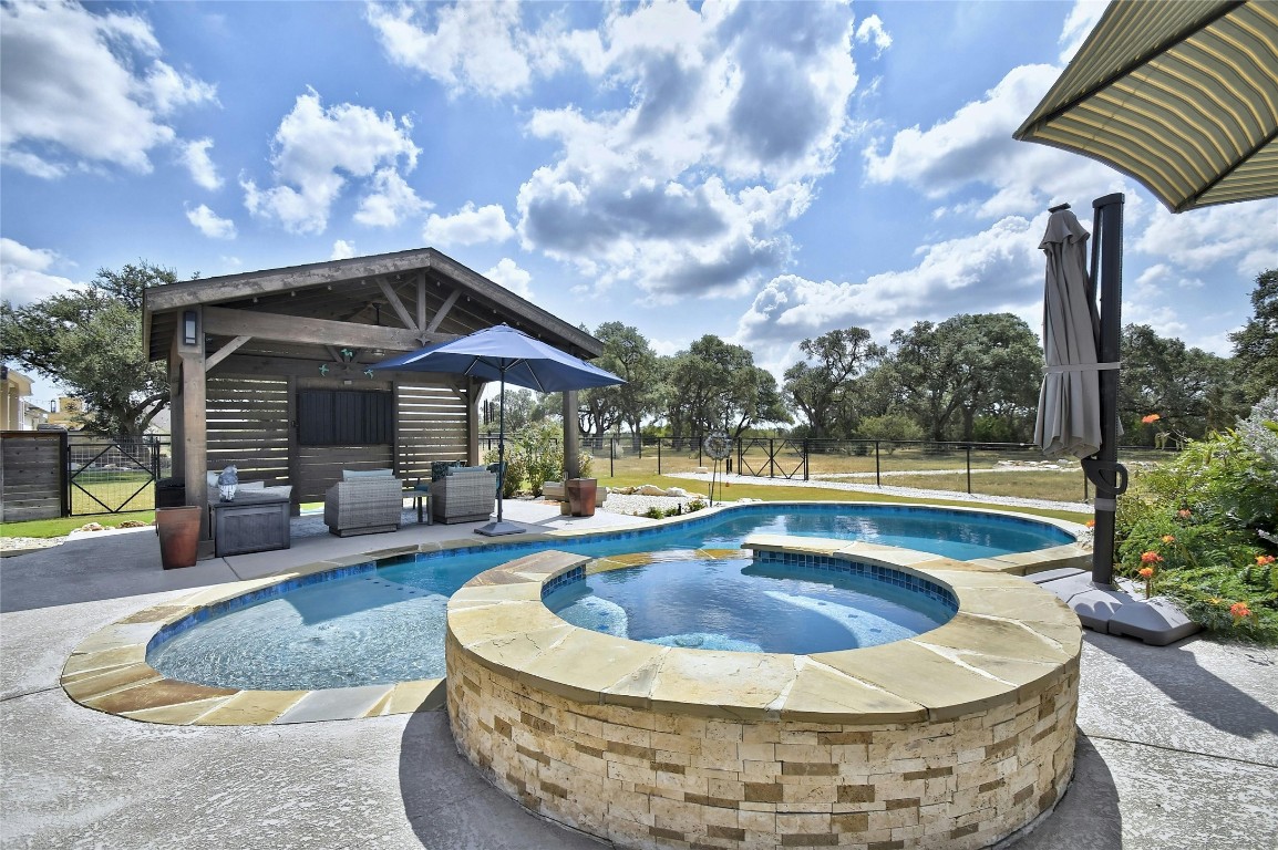 a view of a house with swimming pool and sitting area