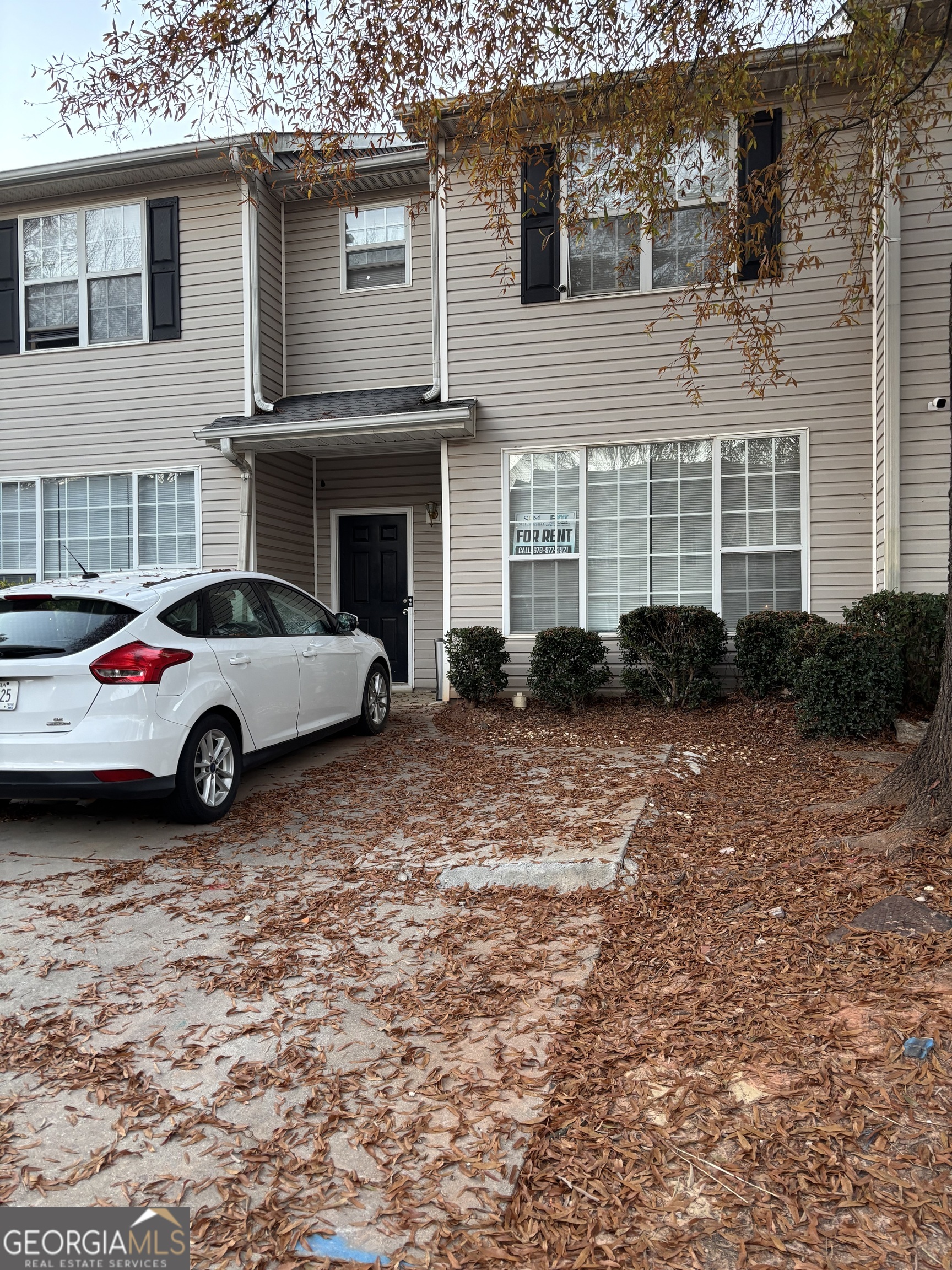 a view of cars parked in front of a house