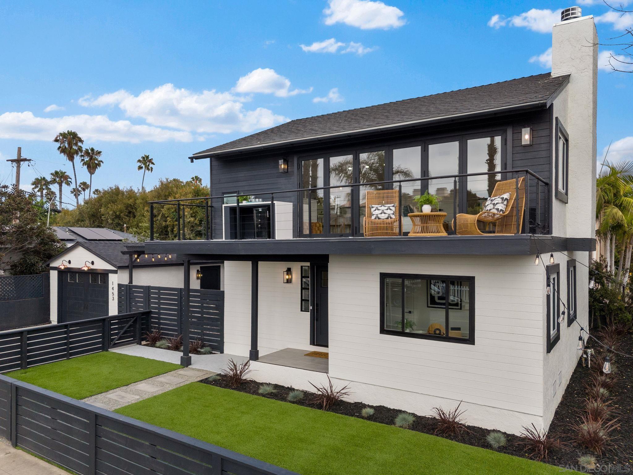 a view of an house with backyard space and balcony