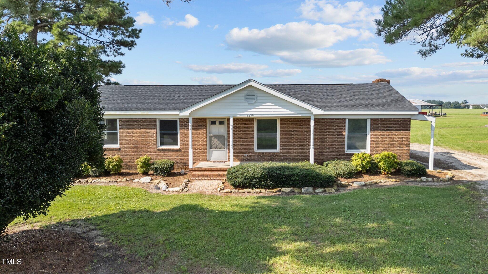 a front view of a house with a yard and porch