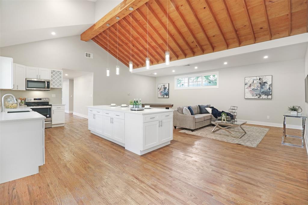 a living room with furniture and kitchen view