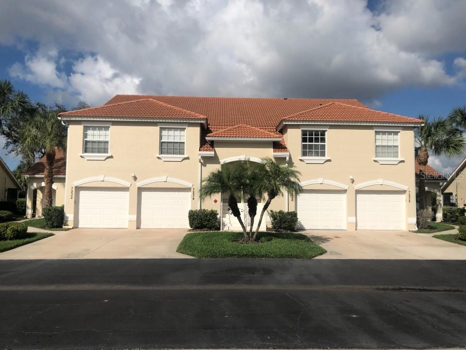 a front view of a house with a yard and garage