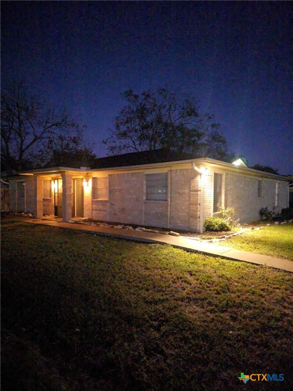 a view of a house with a backyard