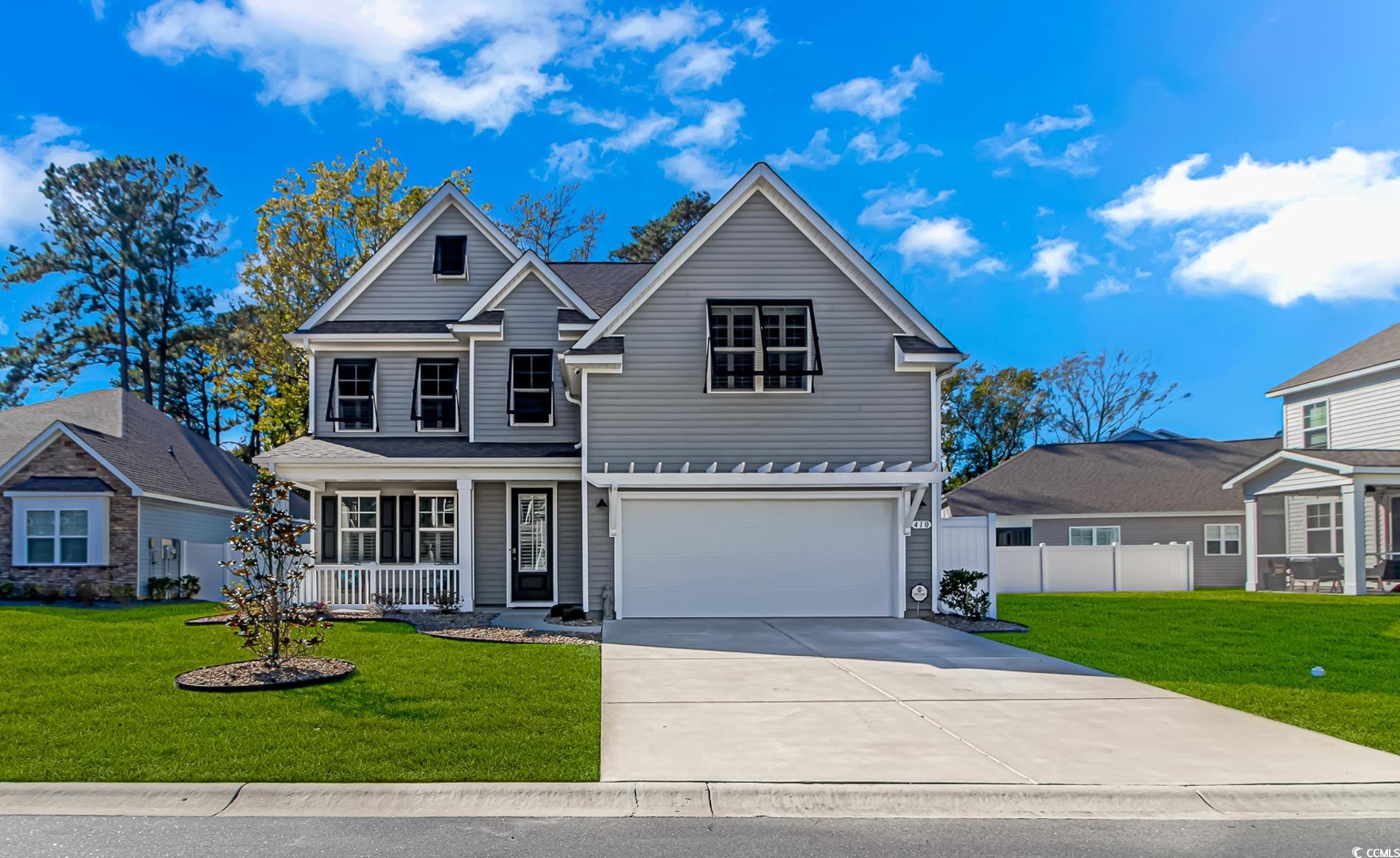 View of front of property with covered porch, a ga