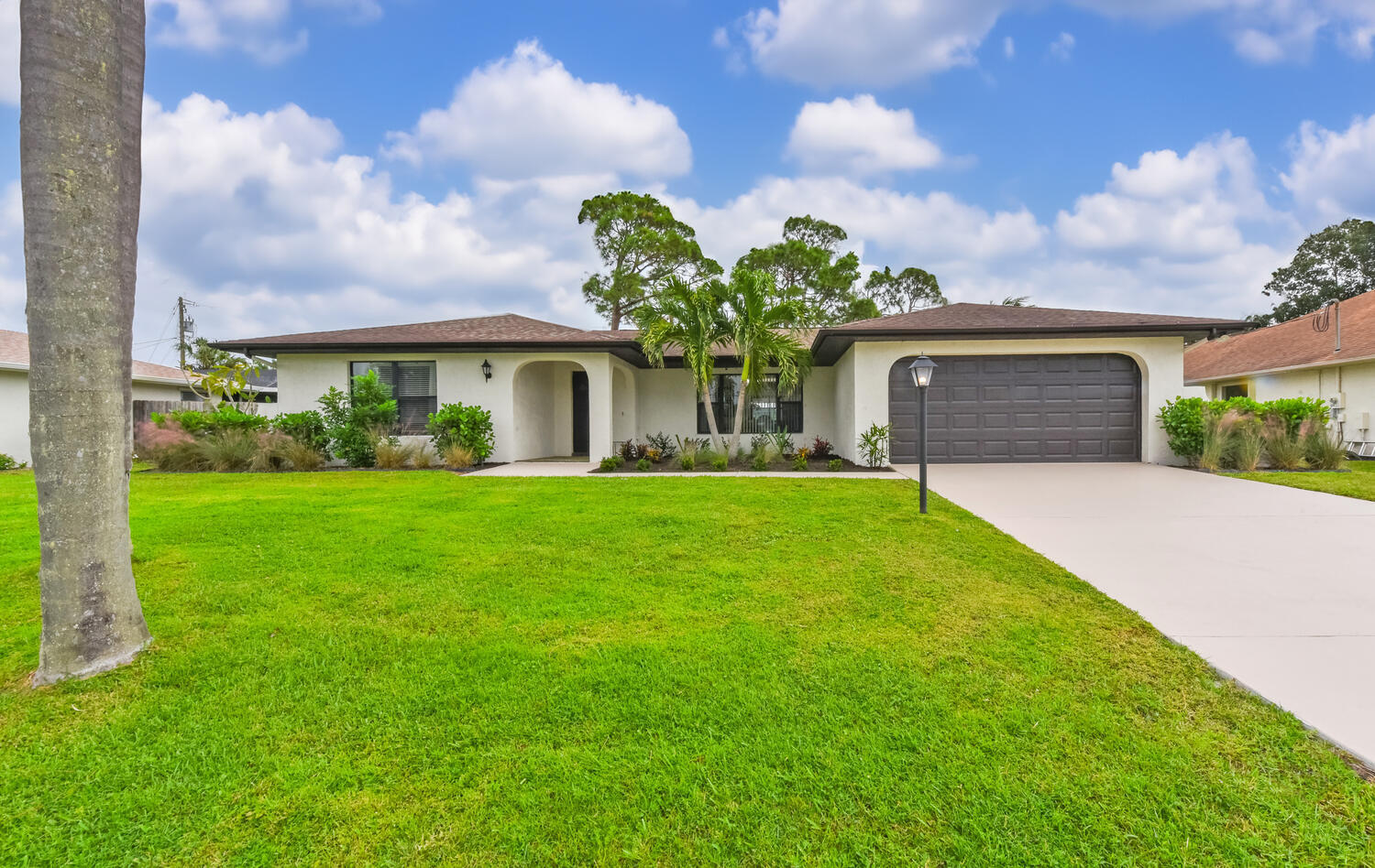 a front view of house with yard and green space