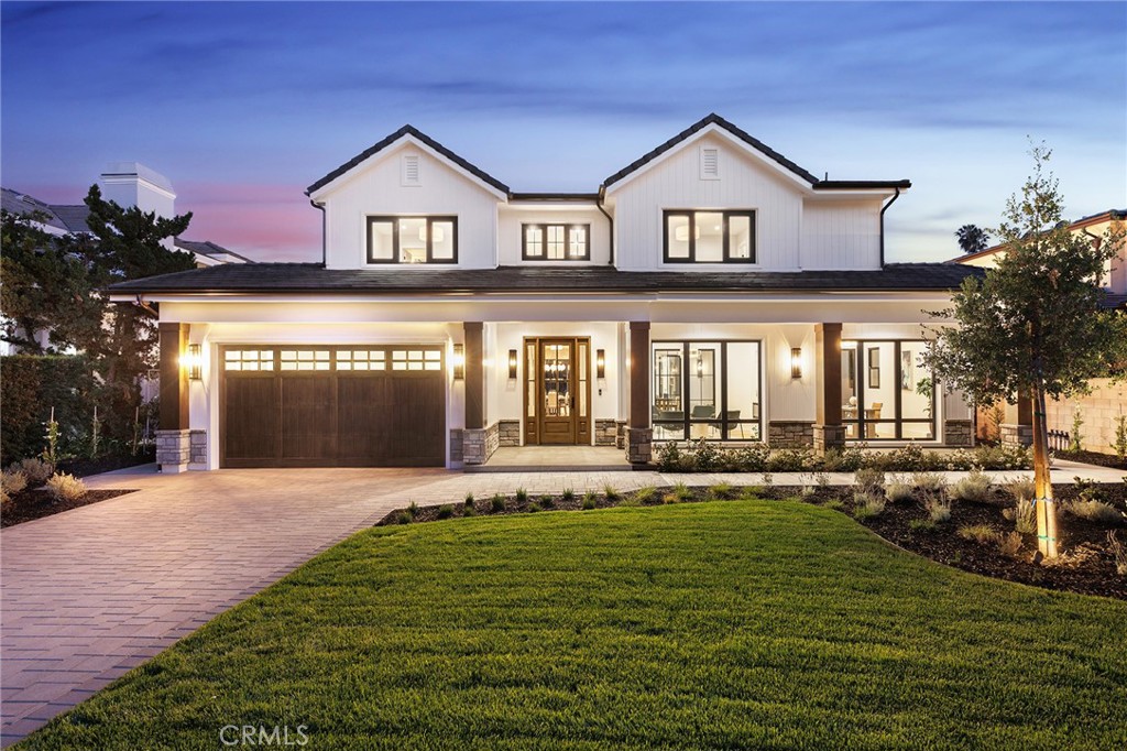 a front view of a house with a yard and outdoor seating