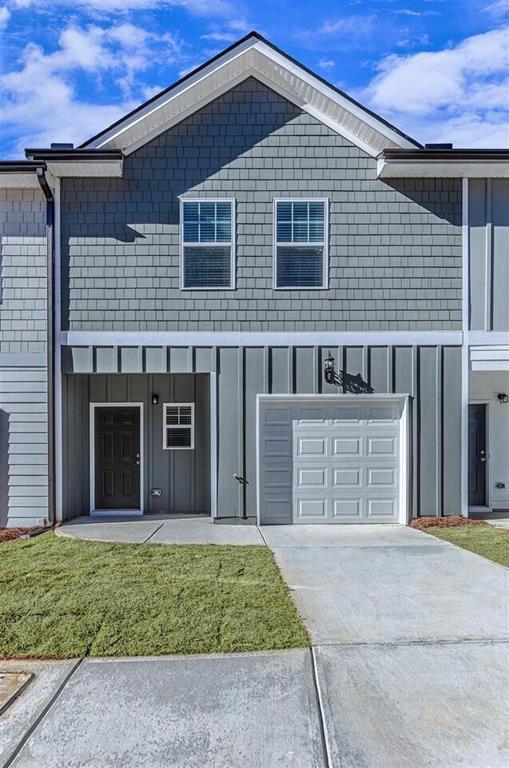 a front view of a house with garage