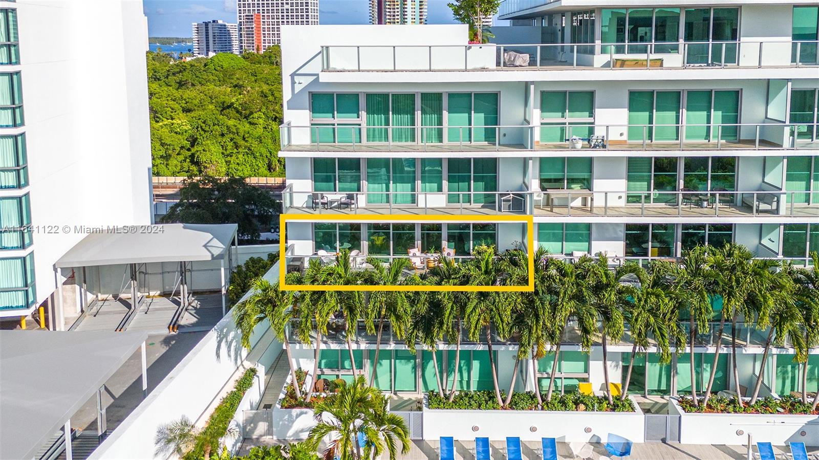 a balcony with tall trees in front of it