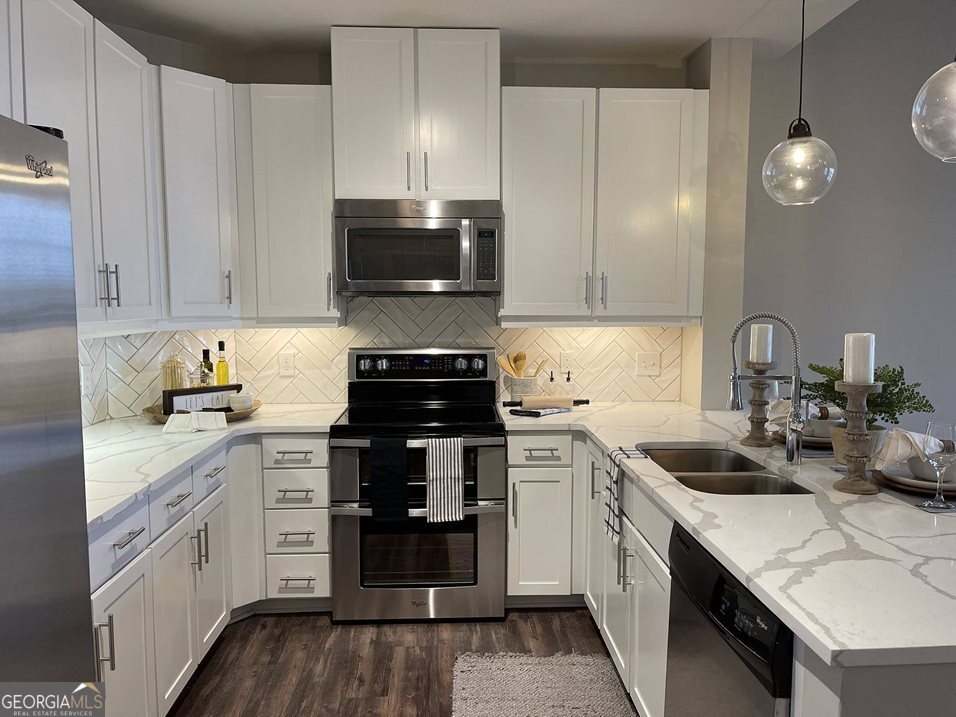 a kitchen with a sink stove and cabinets