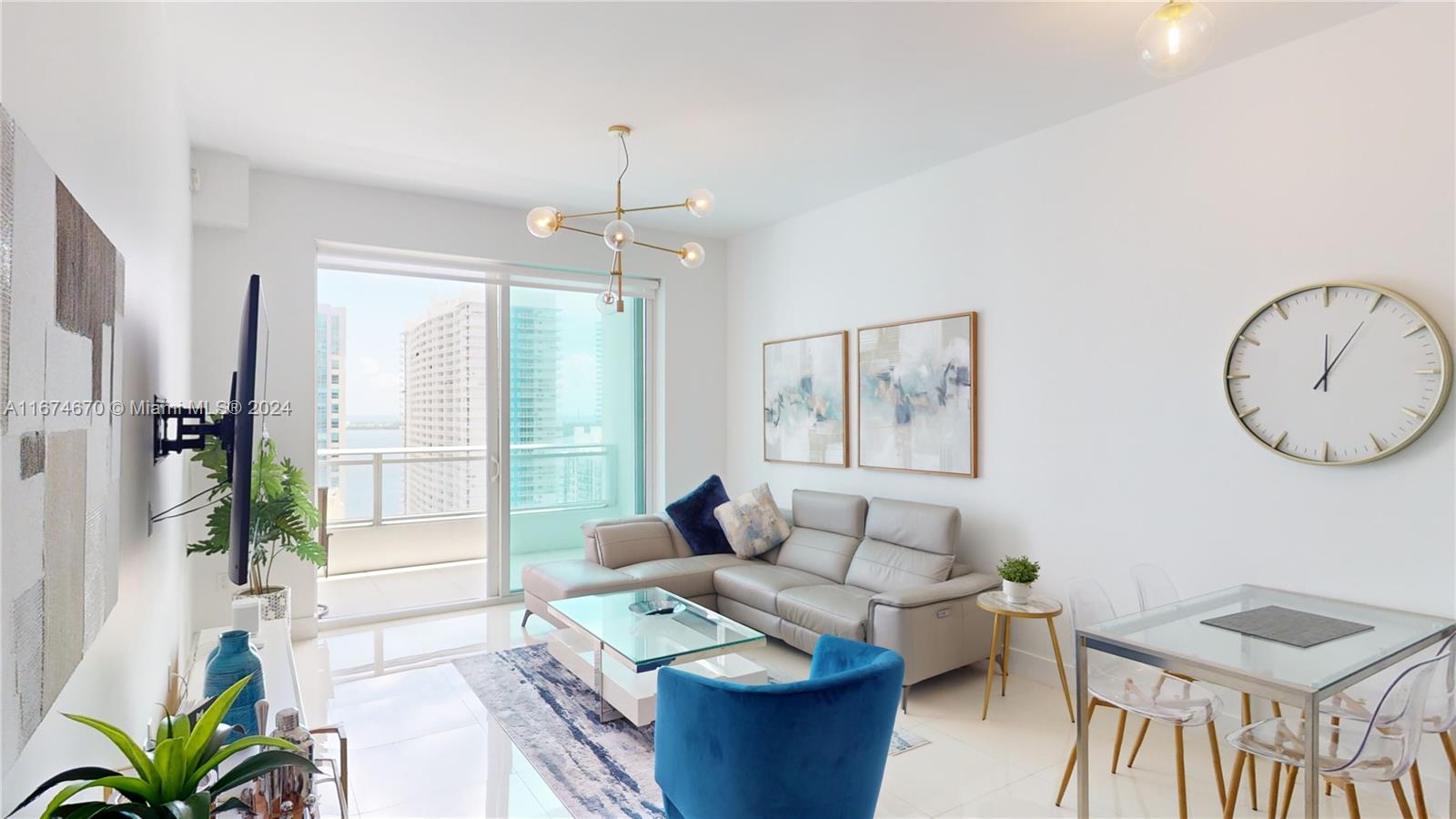 a living room with furniture a window and a chandelier