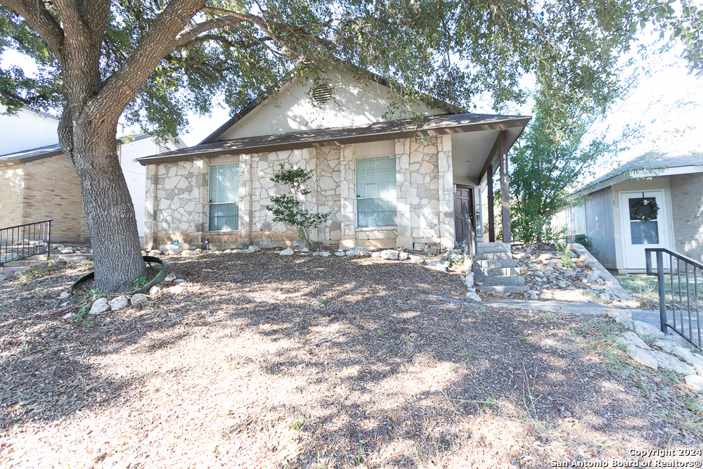 a view of a house with yard and sitting area