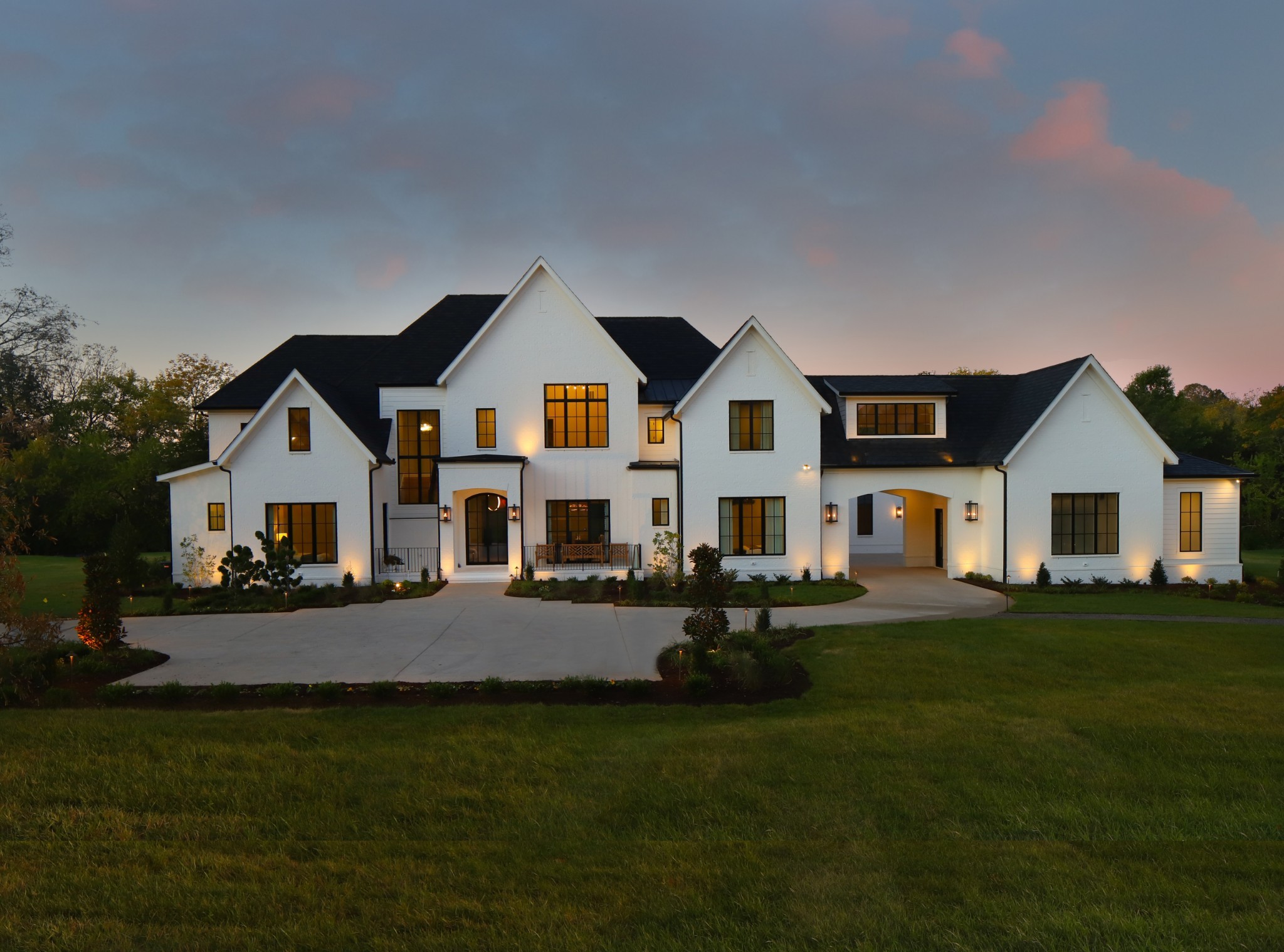 a front view of a house with a garden