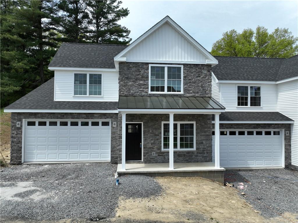 a front view of a house with a garage and yard