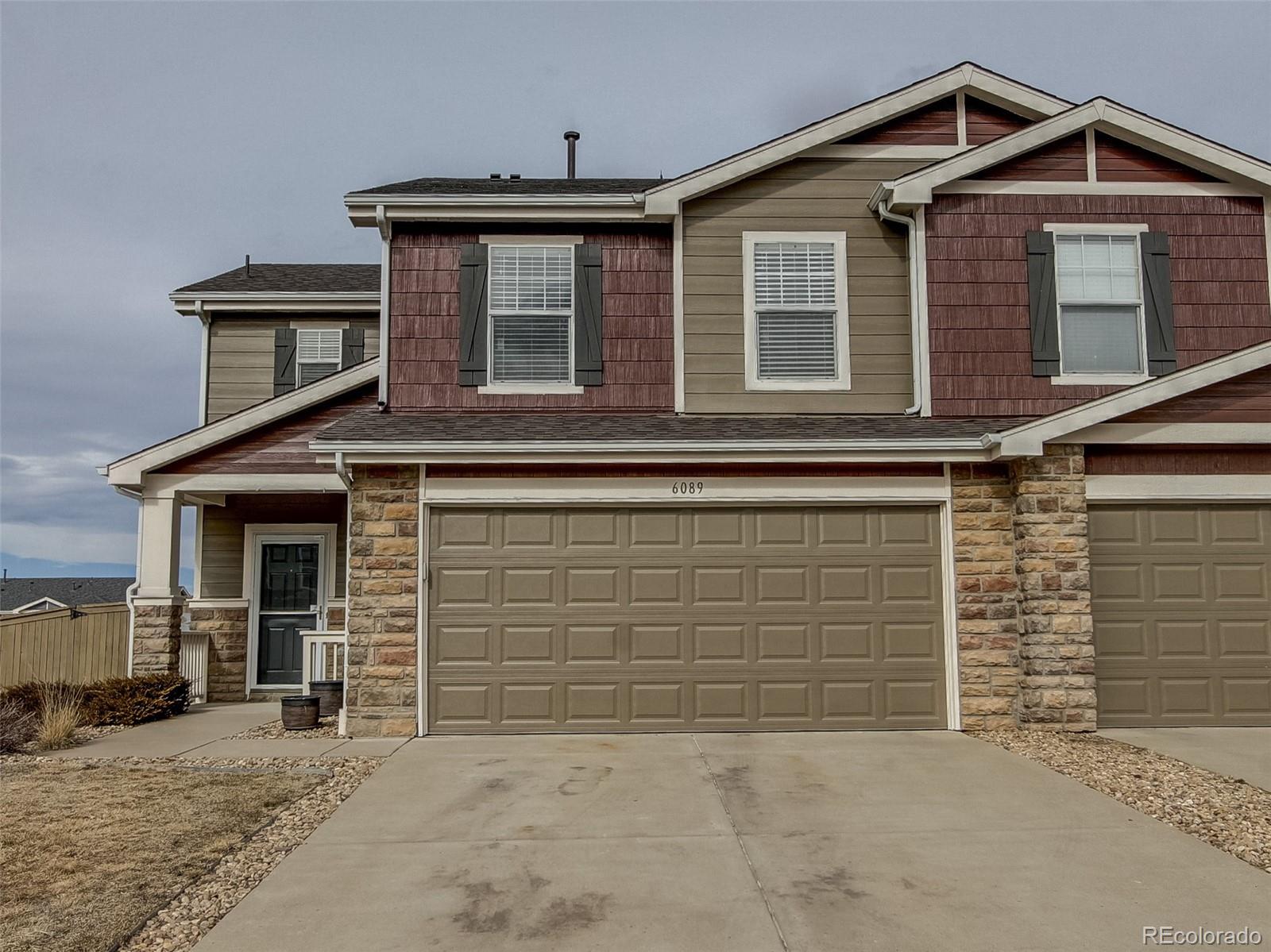 a front view of a house with garage