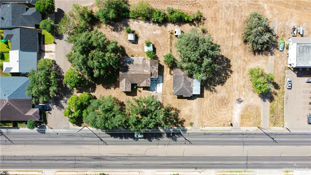 an aerial view of a house with a yard and large trees