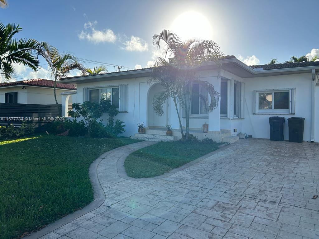 a view of a house with a yard and a garage