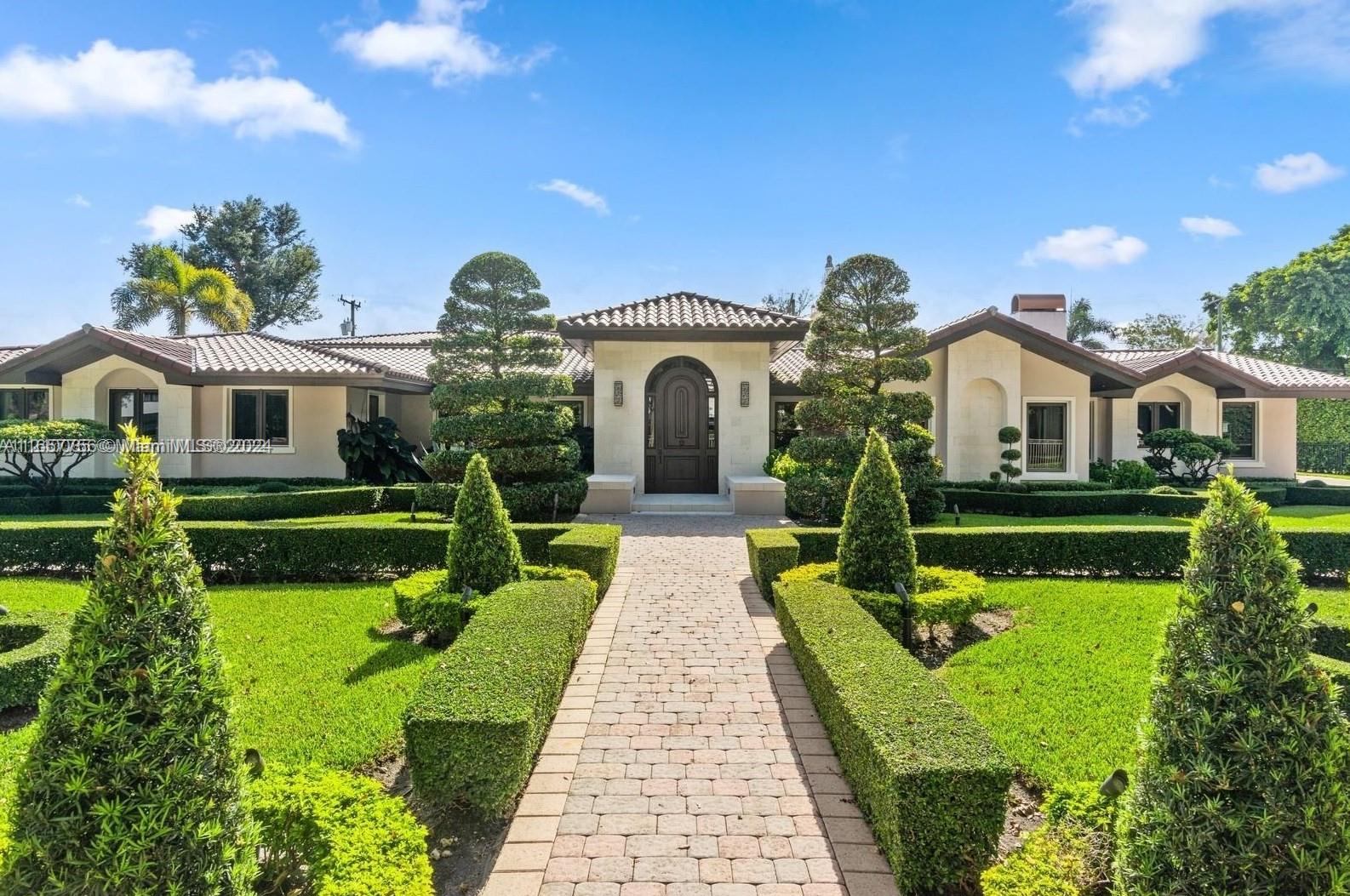 a front view of a house with garden