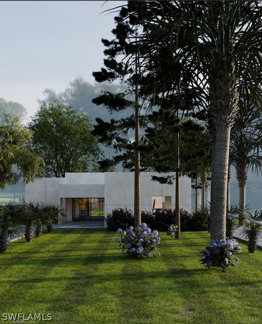 a view of a house with a big yard and large trees