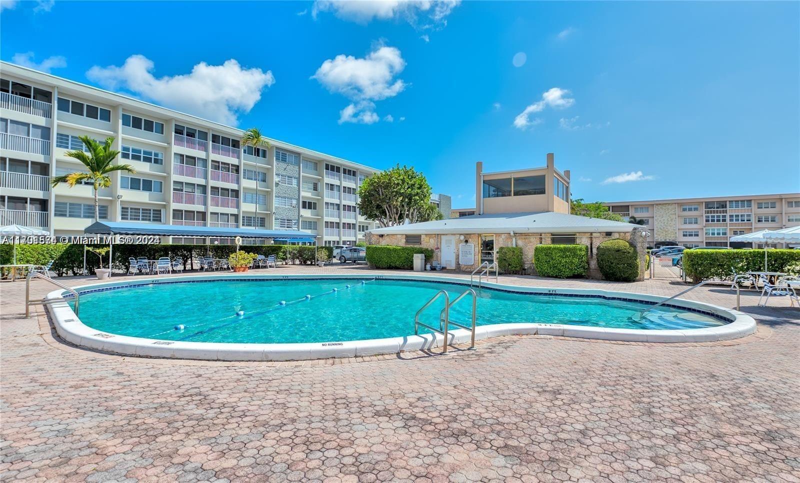 a swimming pool with outdoor seating and yard