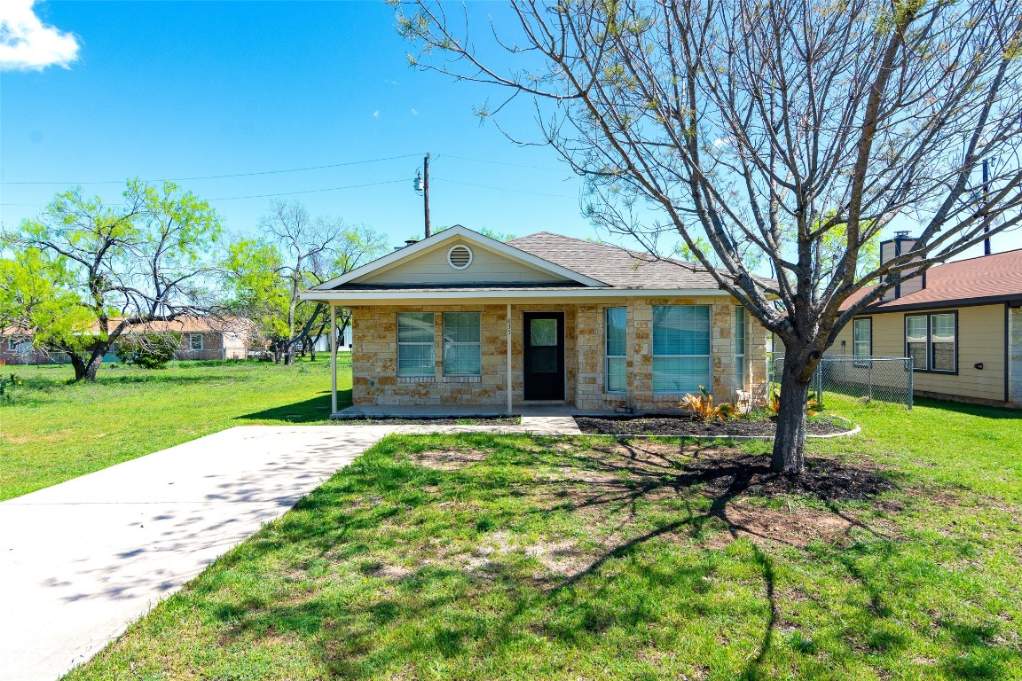 a front view of a house with a garden