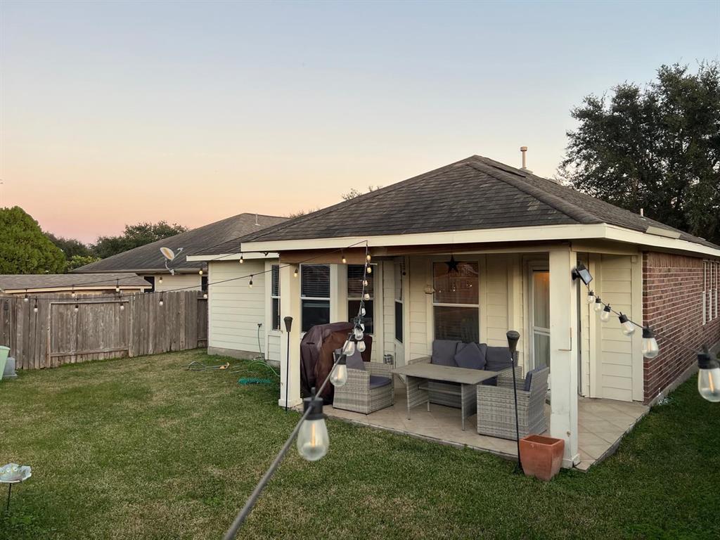 a backyard of a house with table and chairs