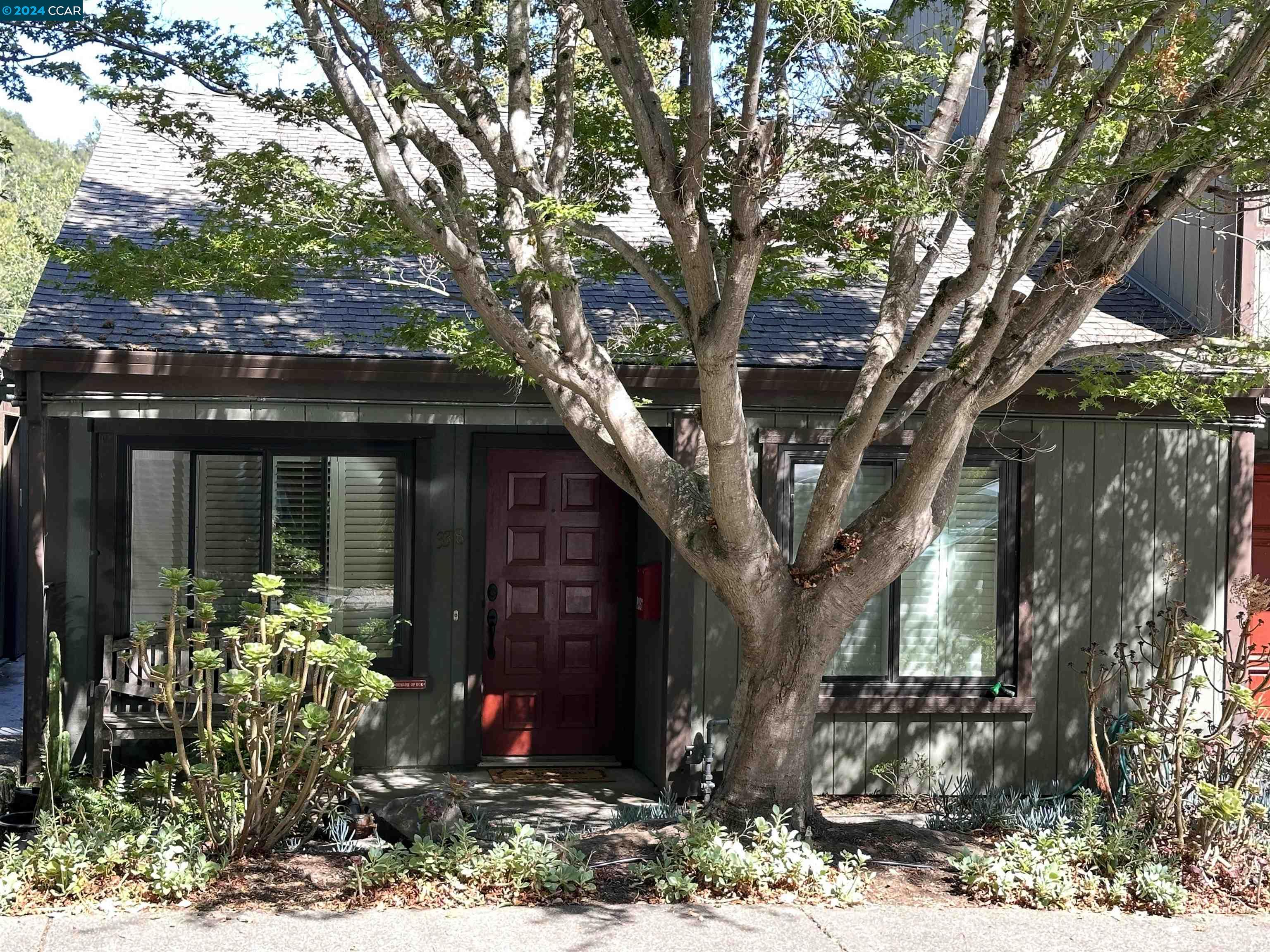 a front view of a house with garden