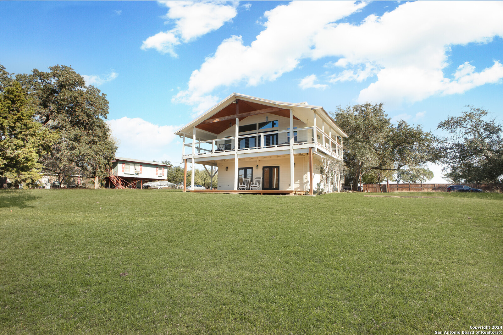 a front view of a house with a big yard