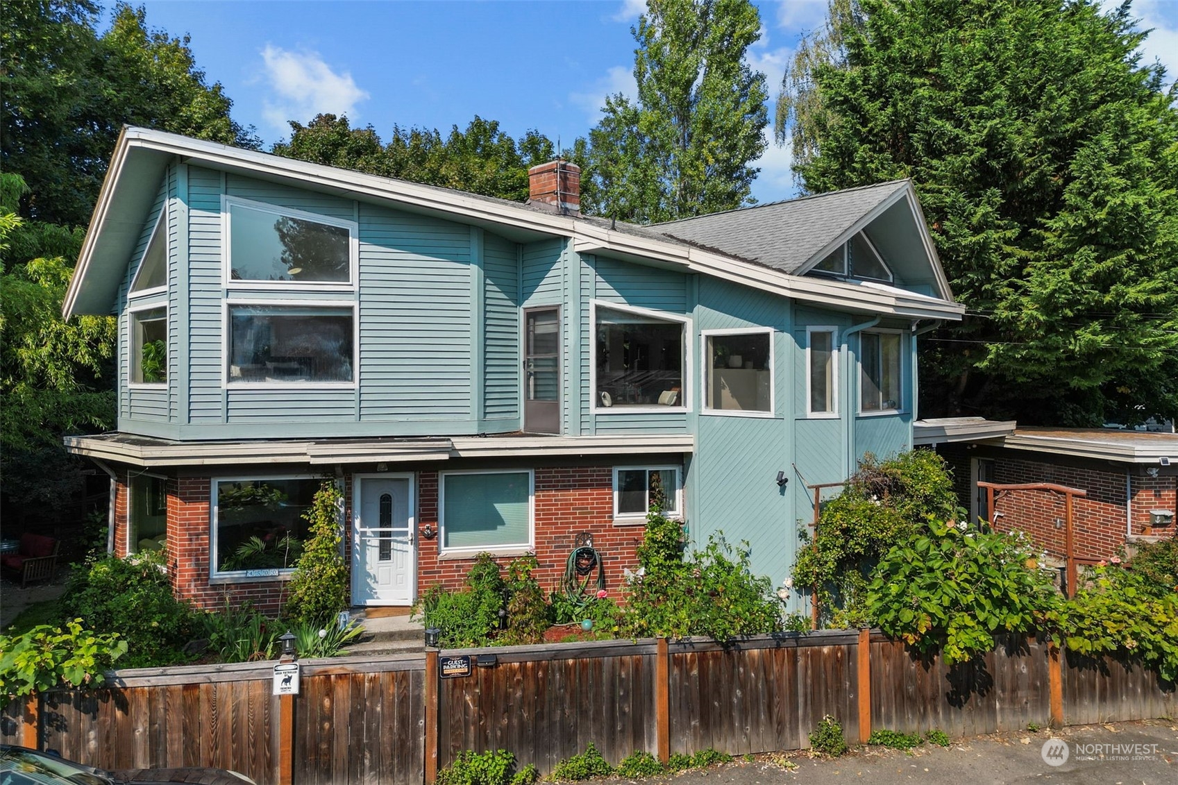 a front view of house with trees in the background