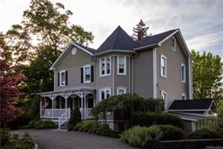 a front view of a house with a yard and plants