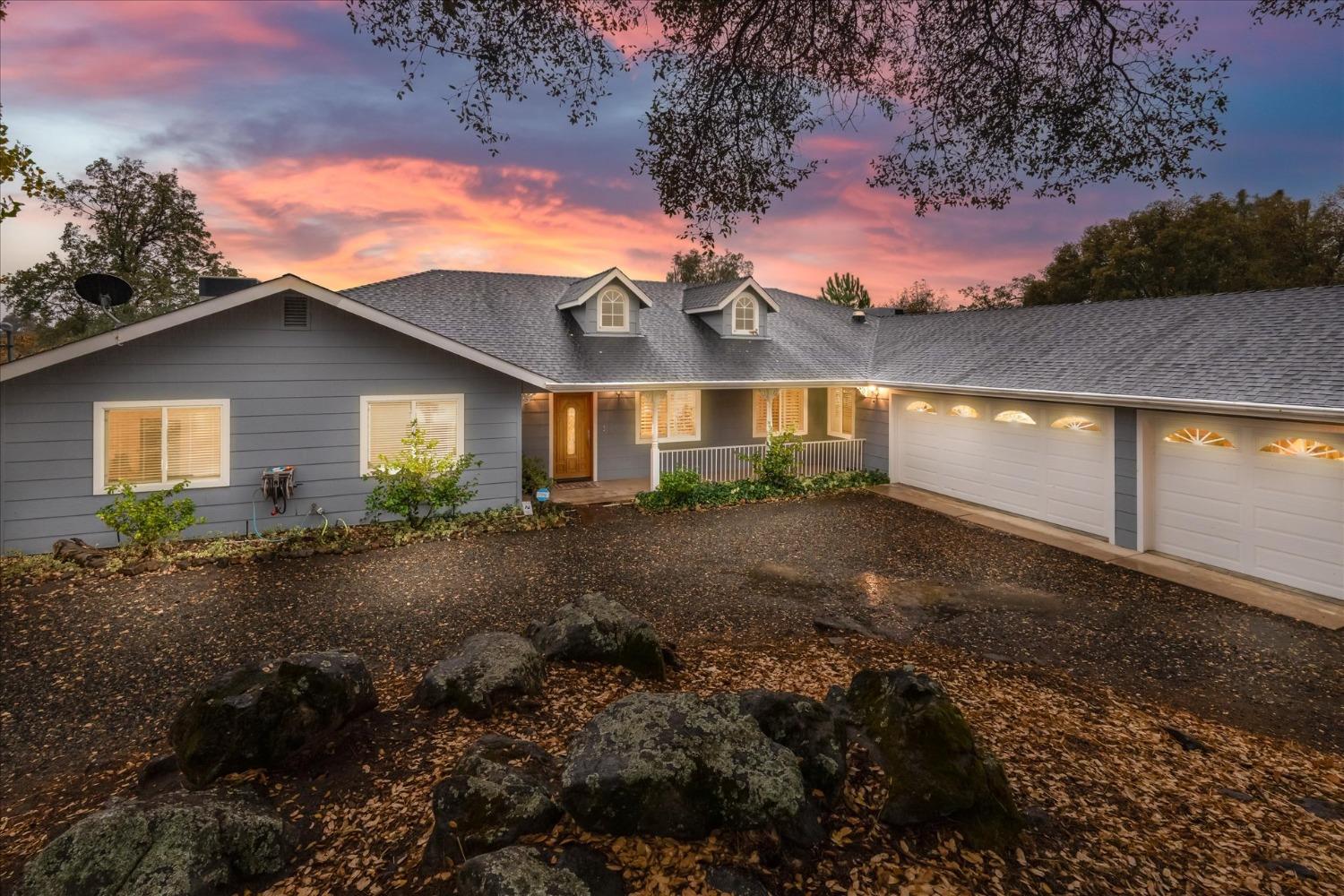 a view of a house with a yard and garage