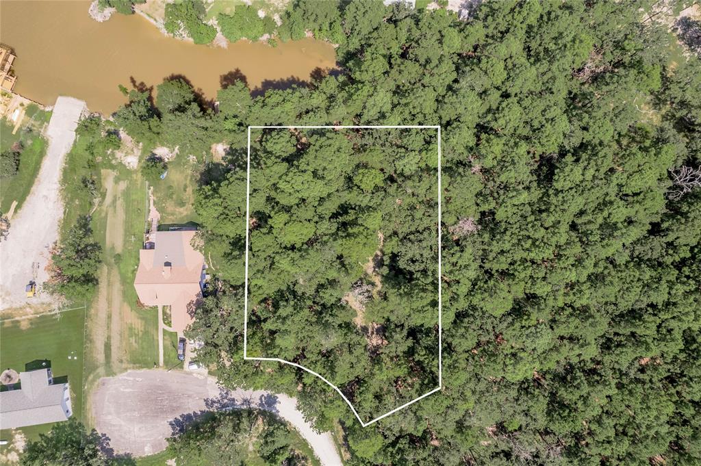 an aerial view of a house with a yard basket ball court and outdoor seating