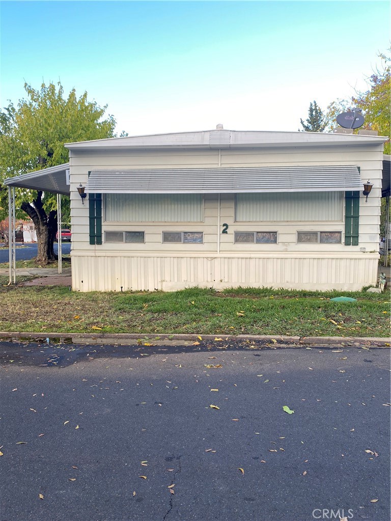 a front view of a house with a yard and a garage