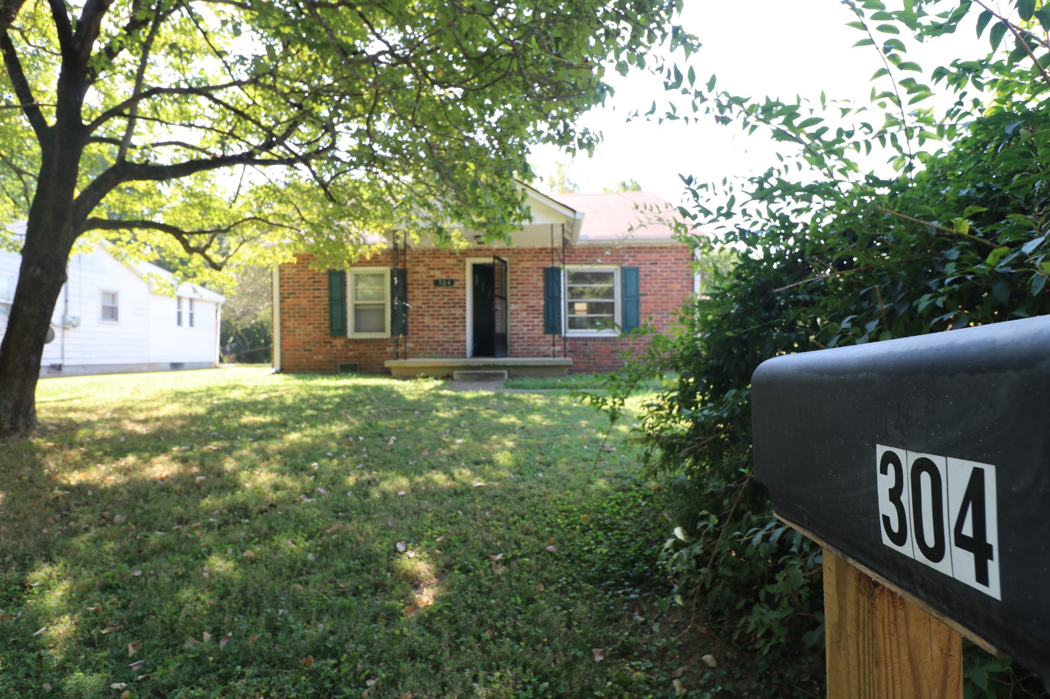 a front view of house with yard and trees