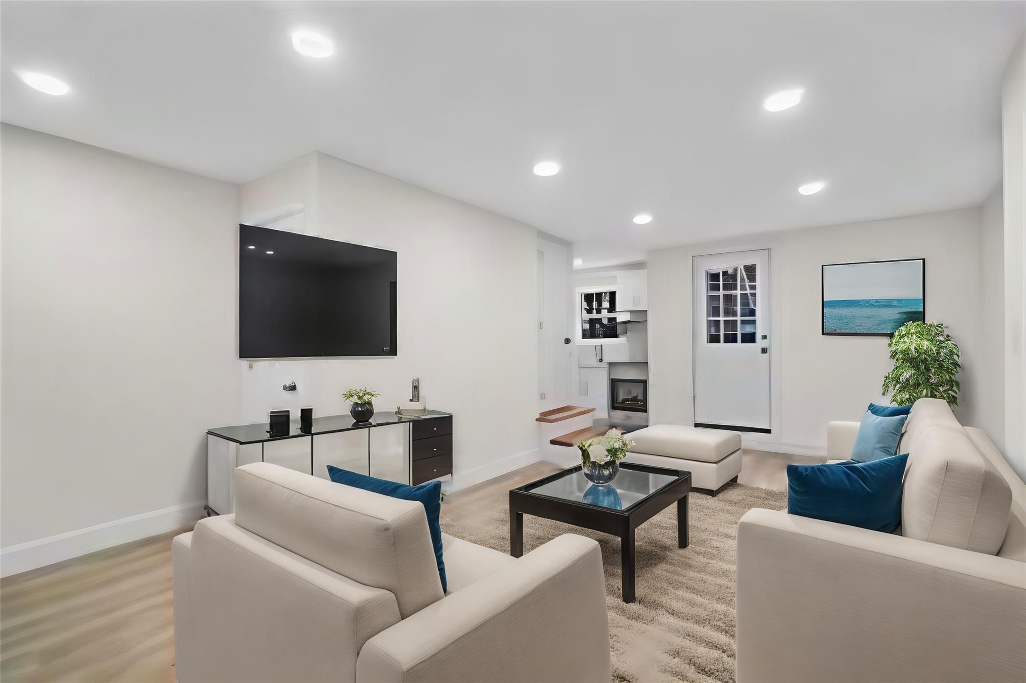 Living room with light hardwood / wood-style flooring