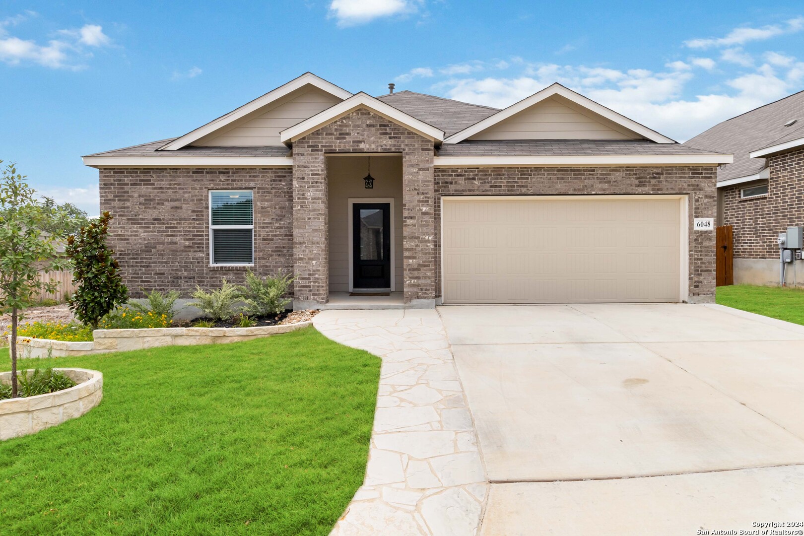 a front view of a house with a yard and garage