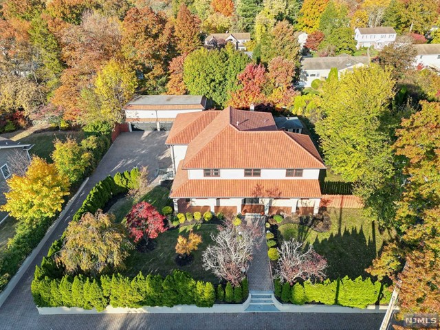 an aerial view of a house with a yard and lake view