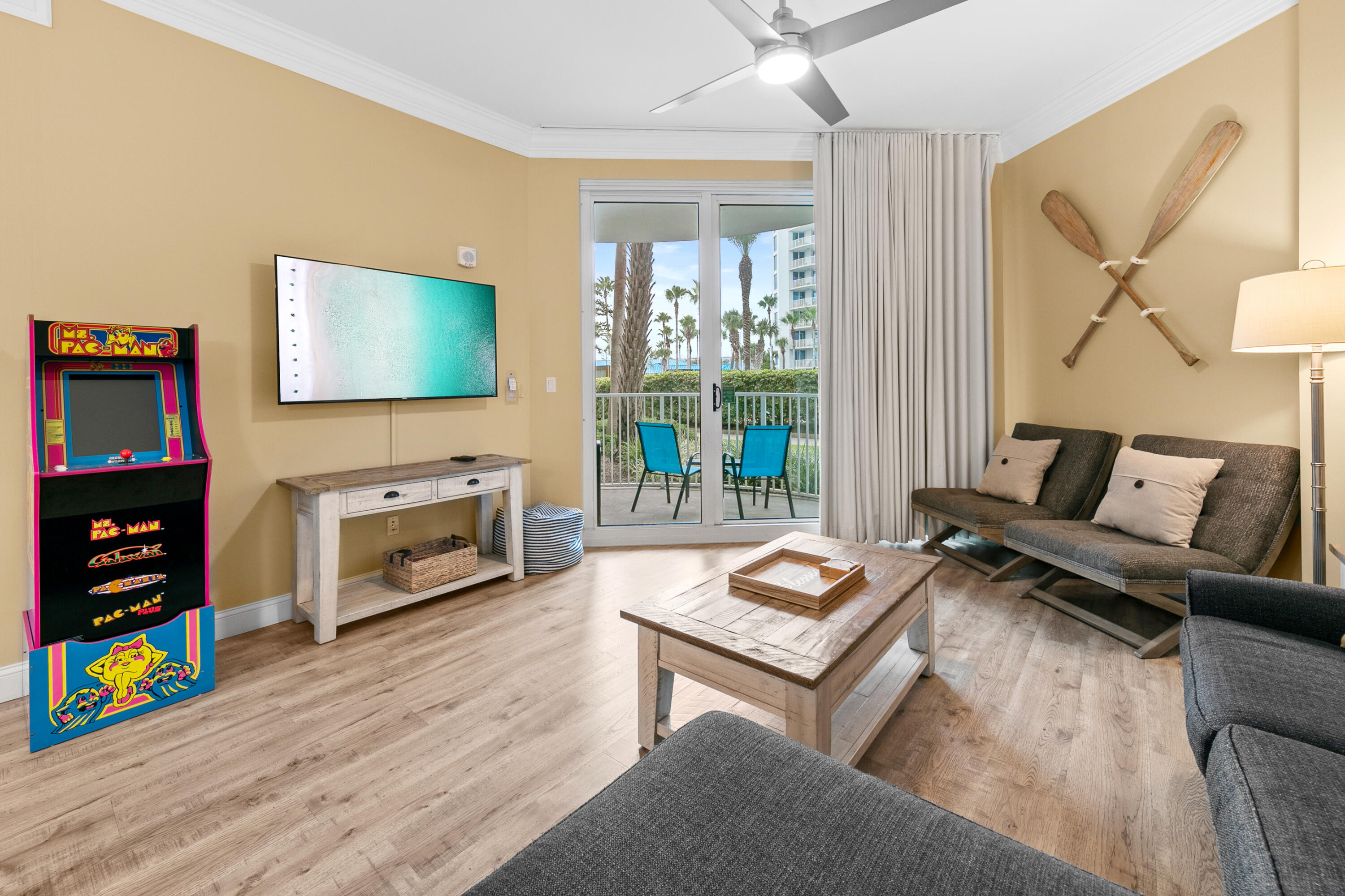 a living room with furniture a flat screen tv and a book shelf