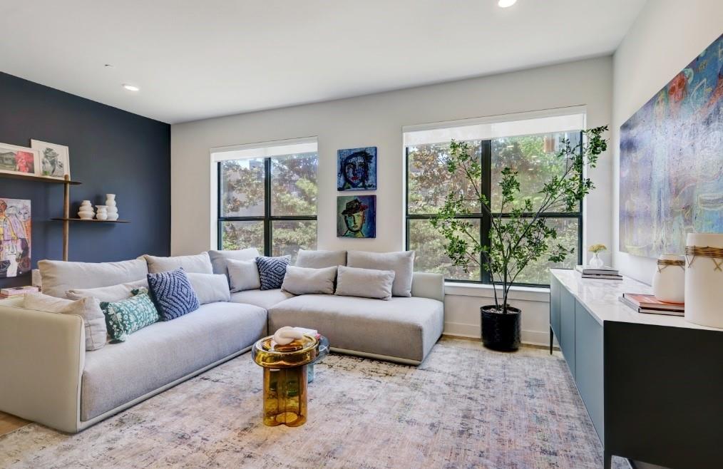 a living room with furniture and a large window